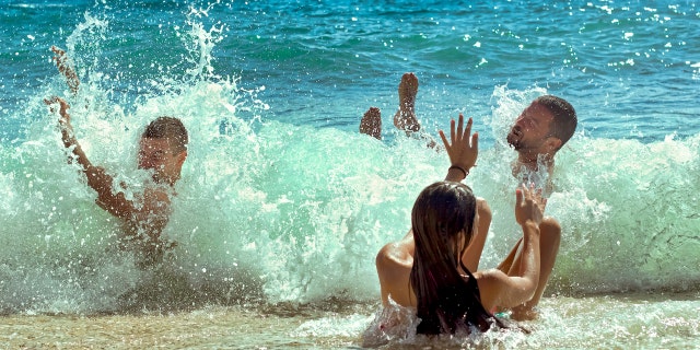 People playing in ocean