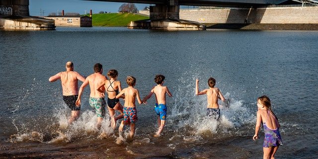 People running into the water