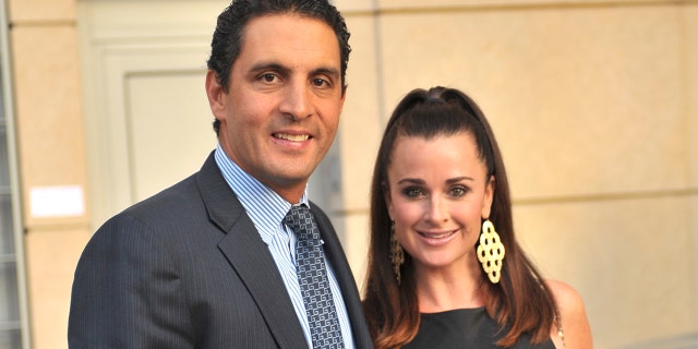 Mauricio Umansky and Kyle Richards pose by a Ferrari at Hollywood event