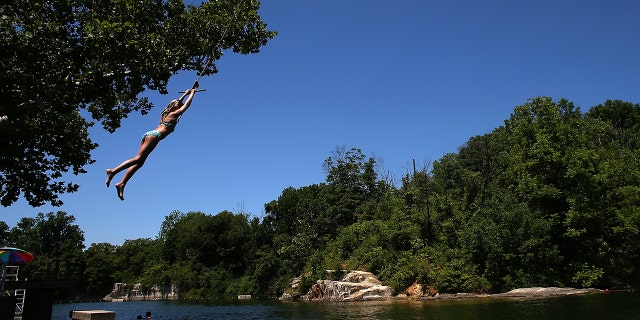 A woman swinging on a rope swing