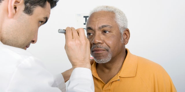 Senior man eye exam