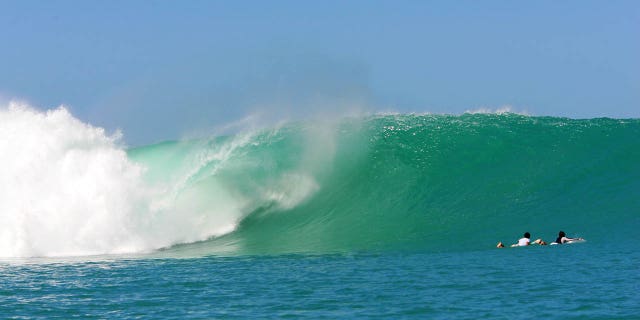 Two surfers in the water of the Mentawai Islands