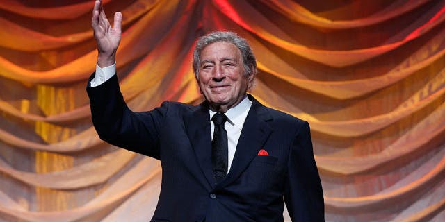 Tony Bennett on stage waving
