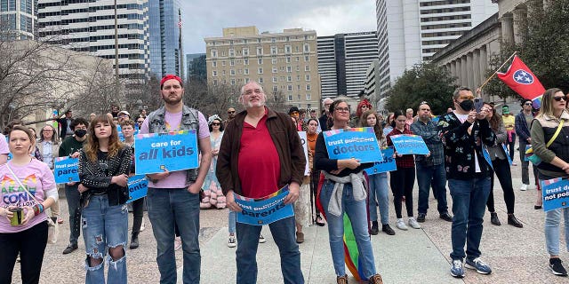 Transgender advocates holding signs