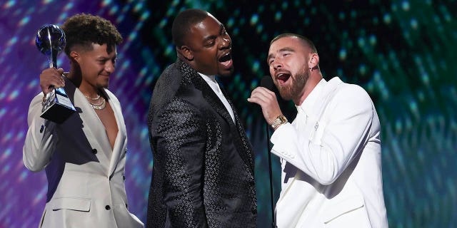 Travis Kelce, Chris Jones, and Patrick Mahomes accept an award at the ESPYs