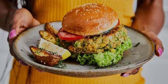 a woman holding a veggie burger