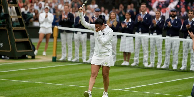 Ons Jabeur receives the runner-up trophy at Wimbledon