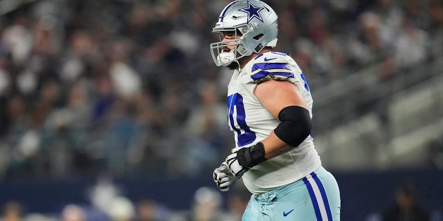 Zack Martin takes the field before a game against the Eagles