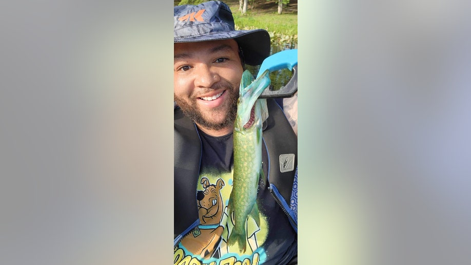 A smiling John Byrd holds up his blue-mouth chain pickerel trophy.