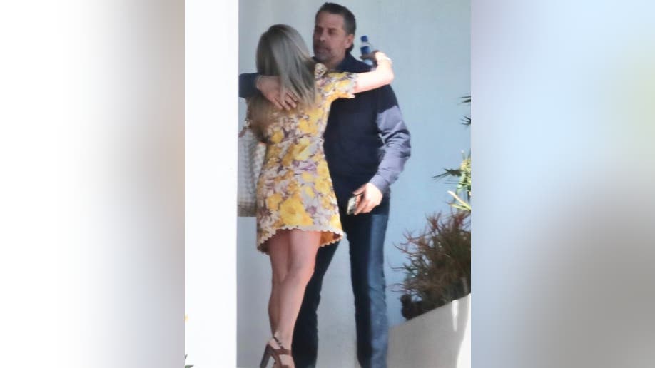 Hunter Biden hugs mystery woman at his lawyer's house