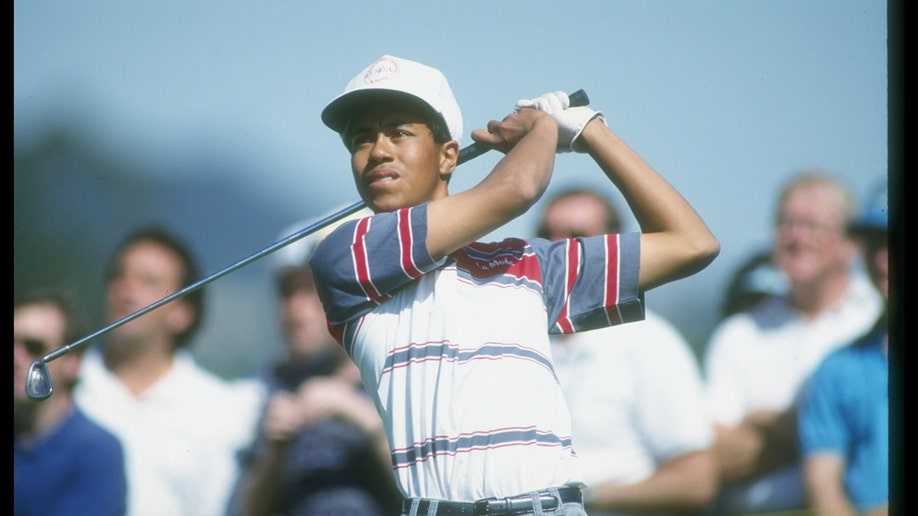Young Tiger Woods watching the golf ball