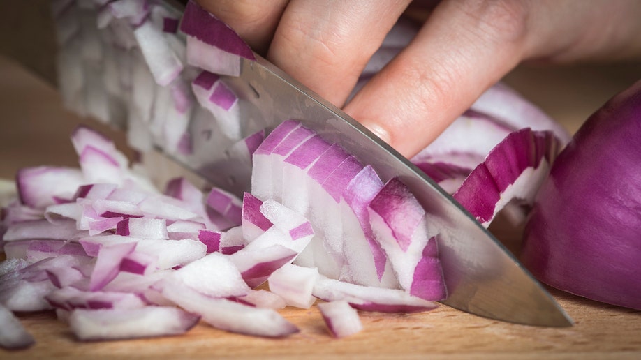 Red onions chopped on board