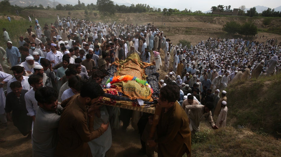 Mourners gather for funerals in Pakistan after deadly suicide bombing at election rally where 54 were killed