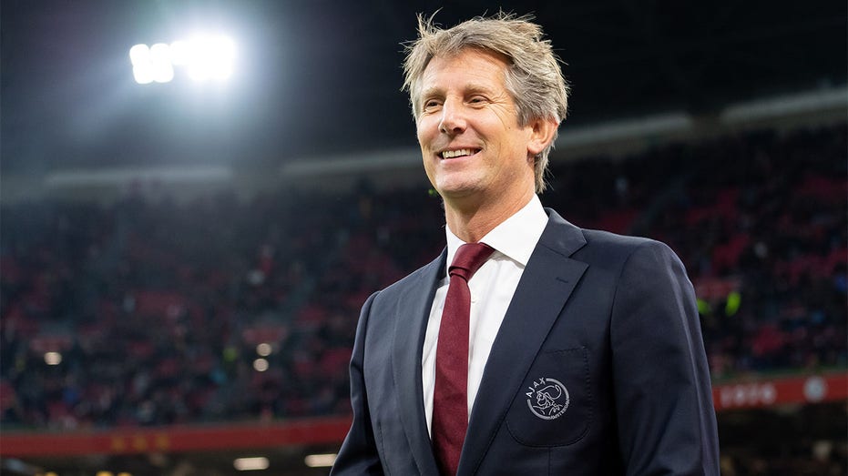 The Ajax squad wearing a goalkeeper jersey with Edwin van der Sar's name on  it. To show their support to the former Ajax goalkeeper and CEO who  suffered a stroke and is