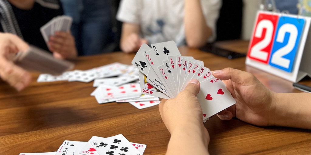 China's financial players turn to Guandan card game amidst shifting investment landscape - Vimarsana News