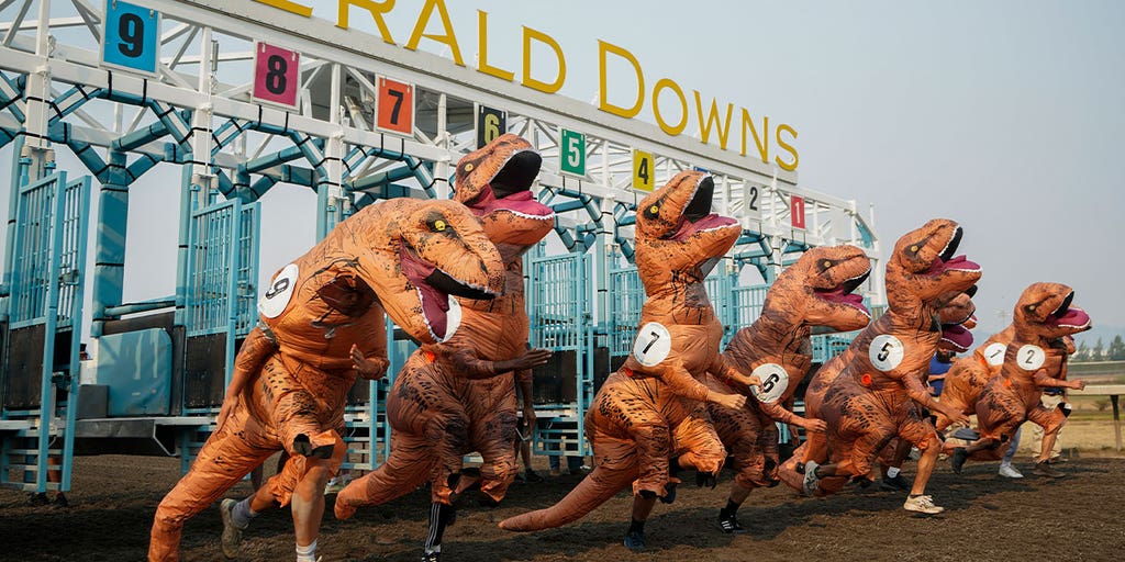 Washington runners take to the race track for a hilarious dinosaur race