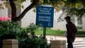 A man walks past an employees entrance sign outside the Theodore Roosevelt Building, headquarters of the U.S. Office of Personnel Management (OPM), in Washington, D.C., U.S., on Friday, June 5, 2015. (Andrew Harrer/Bloomberg via Getty Images)