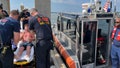 EMS transfer Charles Gregory to a local hospital after Coast Guard crews rescued him off a partially submerged 12-foot jon boat 12 miles offshore St. Augustine, Florida, Aug. 5, 2023.