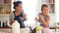 Shot of a little girl having fun baking with her mother in the kitchen