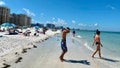 People gather at Clearwater Beach in the Tampa Bay, Florida area as the beach was officially open to the public on May 4, 2020. (Photo by Daniel SLIM / AFP) (Photo by DANIEL SLIM/AFP via Getty Images)