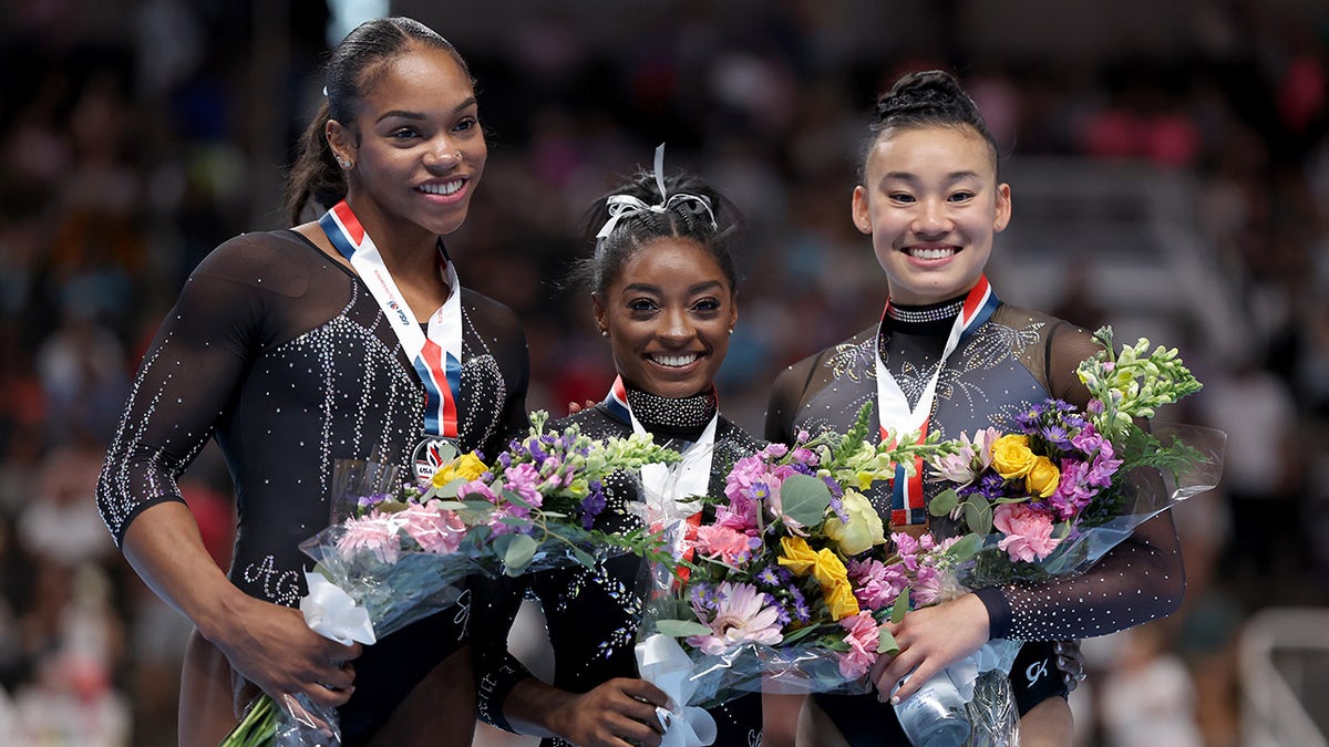 Simone Biles poses with Shi Jones and Leanne Wong