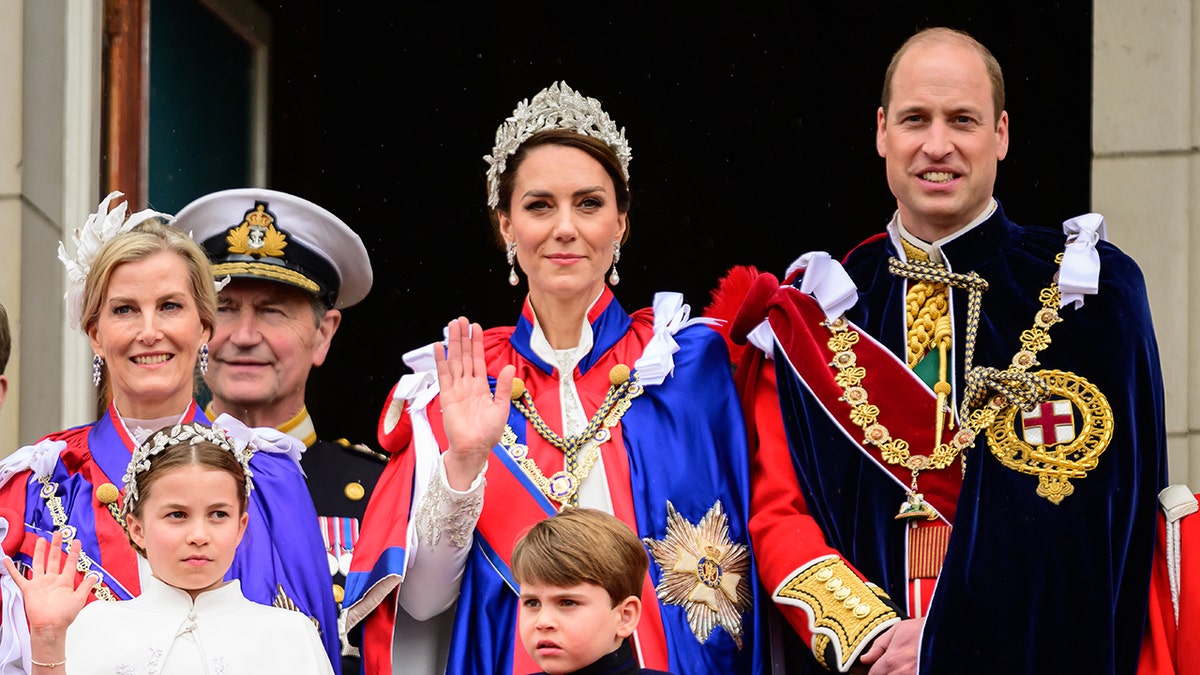 Kate Middleton wearing royal regalia while being surrounded by the British royal family