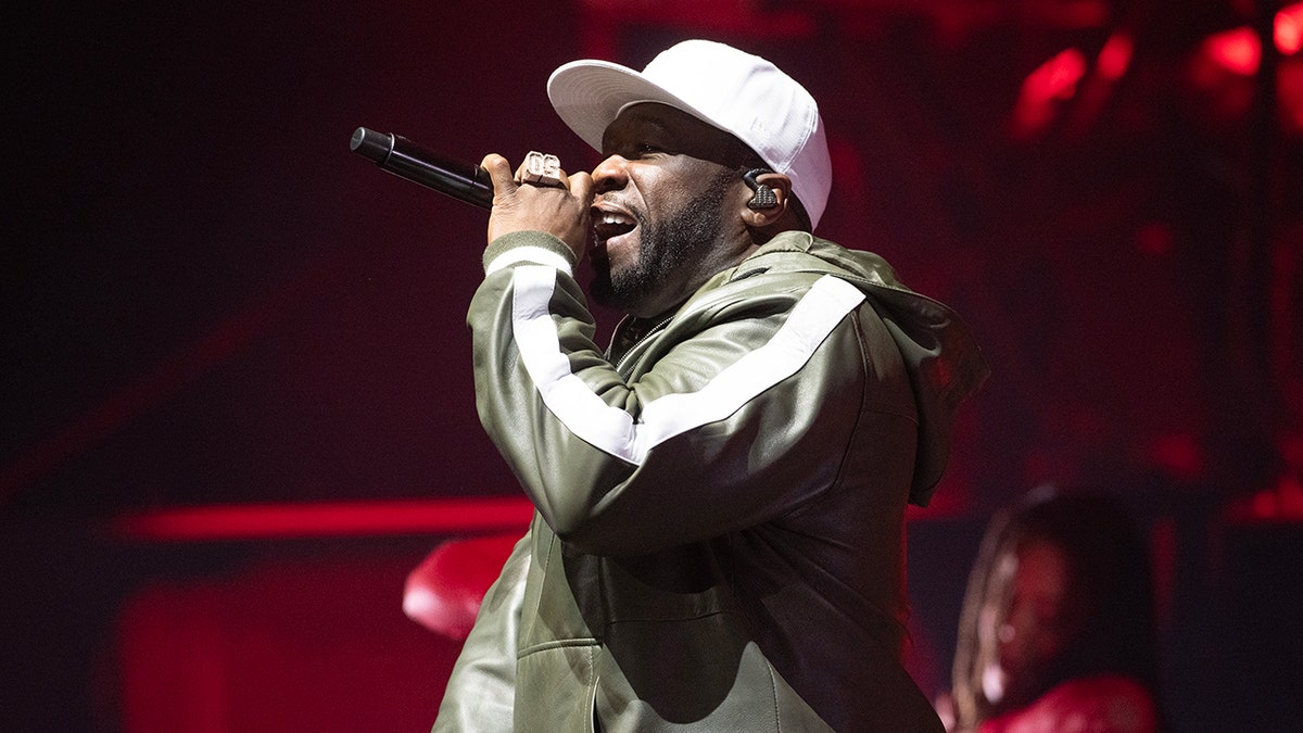 Close up of 50 Cent performing with microphone