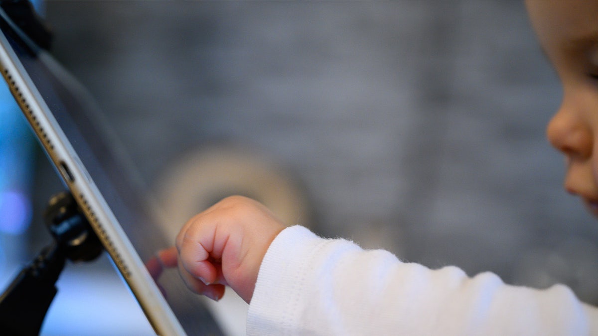 A child operates a tablet