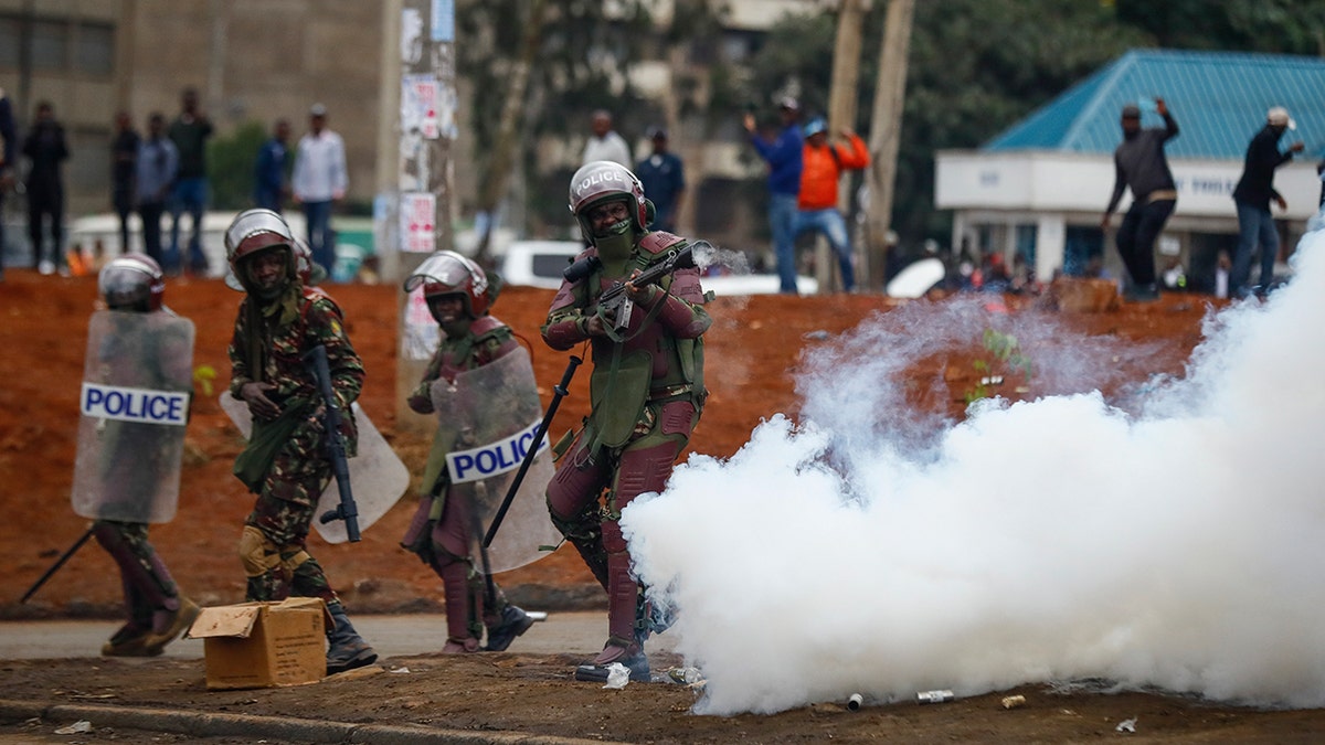 Riot police fire tear gas grenades