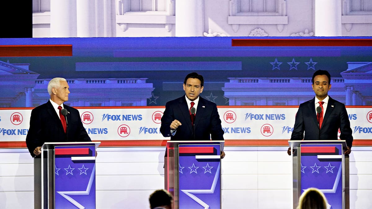 Former Vice President Mike Pence, 2024 Republican presidential candidate, from left, Ron DeSantis, governor of Florida and 2024 Republican presidential candidate, and Vivek Ramaswamy, chairman and co-founder of Strive Asset Management and 2024 Republican presidential candidate, during the Republican primary presidential debate hosted by Fox News in Milwaukee, Wisconsin, US, on Wednesday, Aug. 23, 2023. Republican presidential contenders are facing off in their first debate of the primary season, minus frontrunner Donald Trump, who continues to lead his GOP rivals by a double-digit margin. Photographer: Al Drago/Bloomberg via Getty Images