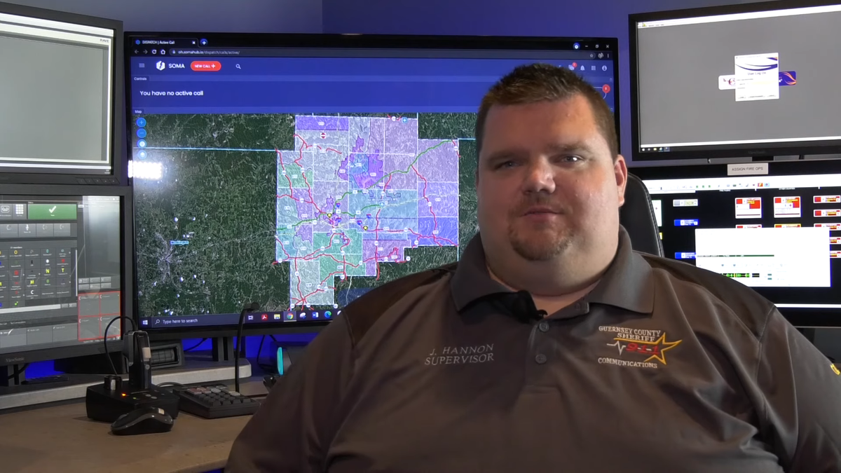 Ohio 911 dispatcher in front of monitor