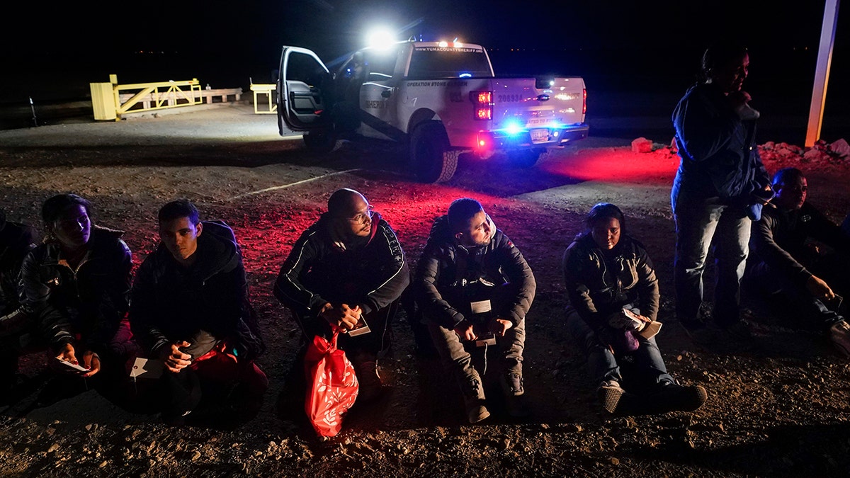 Migrants wait to be processed