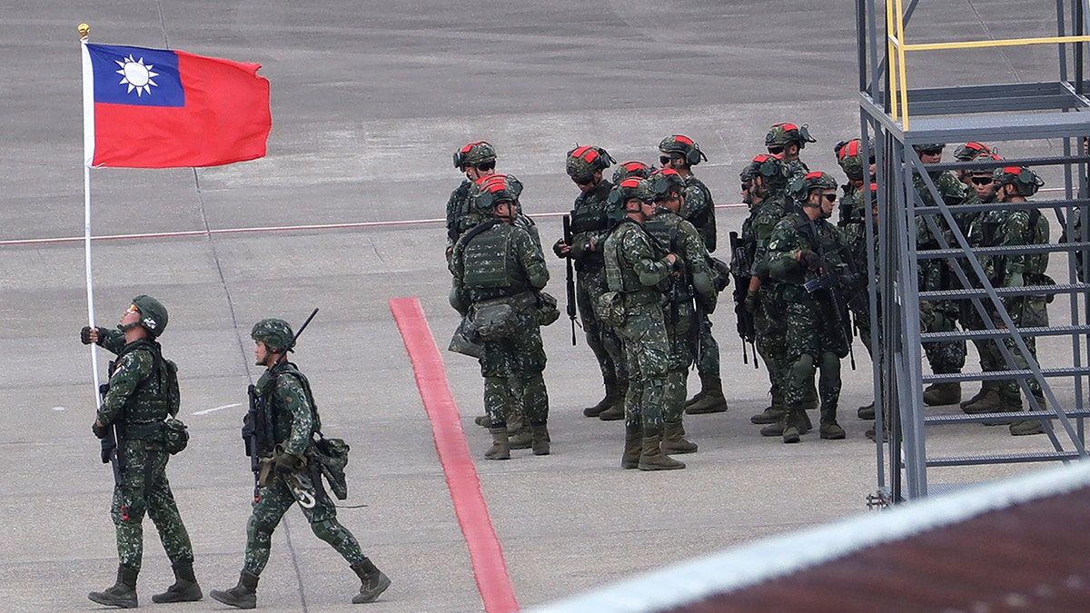 A Taiwanese soldier holding taiwan flag
