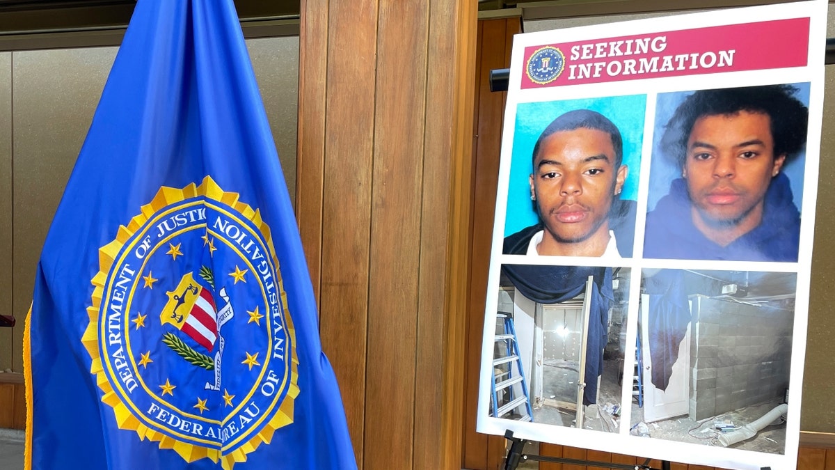 Photos of Negasi Zuberi shown on a poster during an FBI press conference