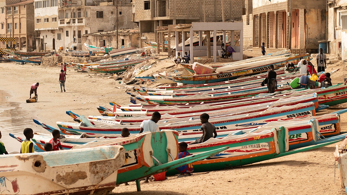 Children play on fishing boats