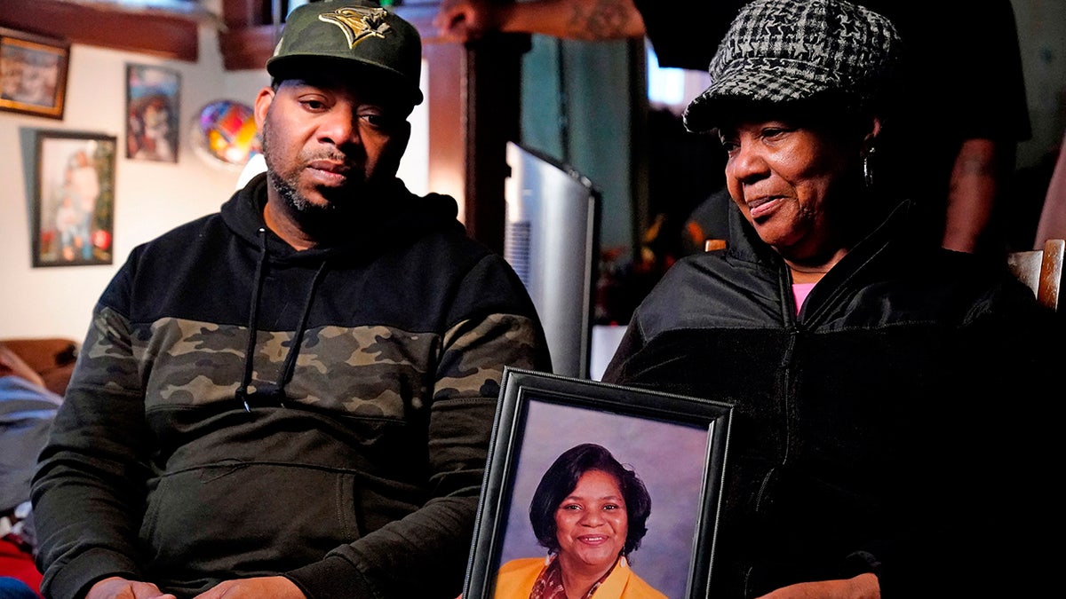 Tops supermarket shooting victim's photo held by family members