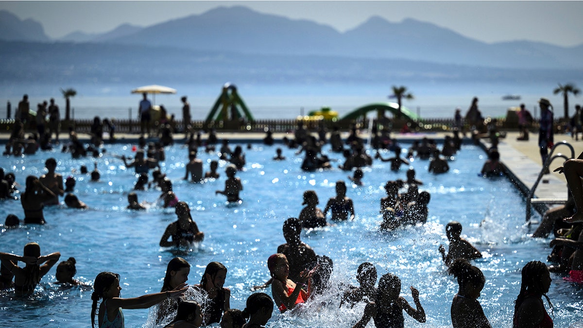 People cool off in the water during hot weather