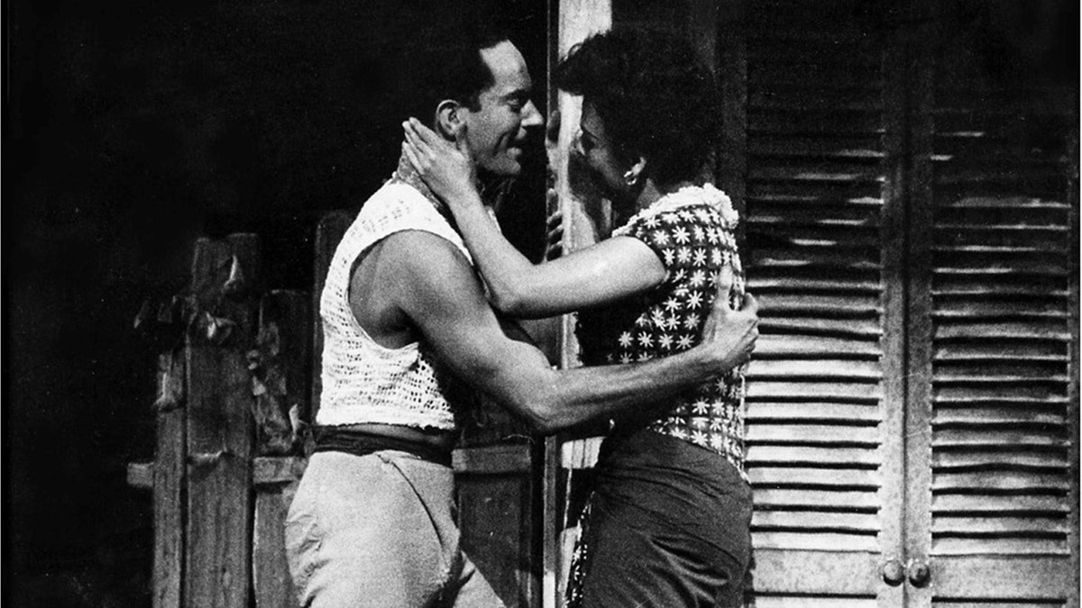 Alan Shayne embracing Lena Horne during a scene of Jamaica on stage