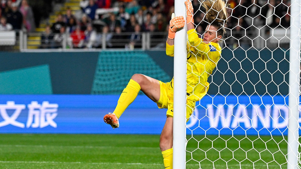 Alyssa Naeher collides with the post