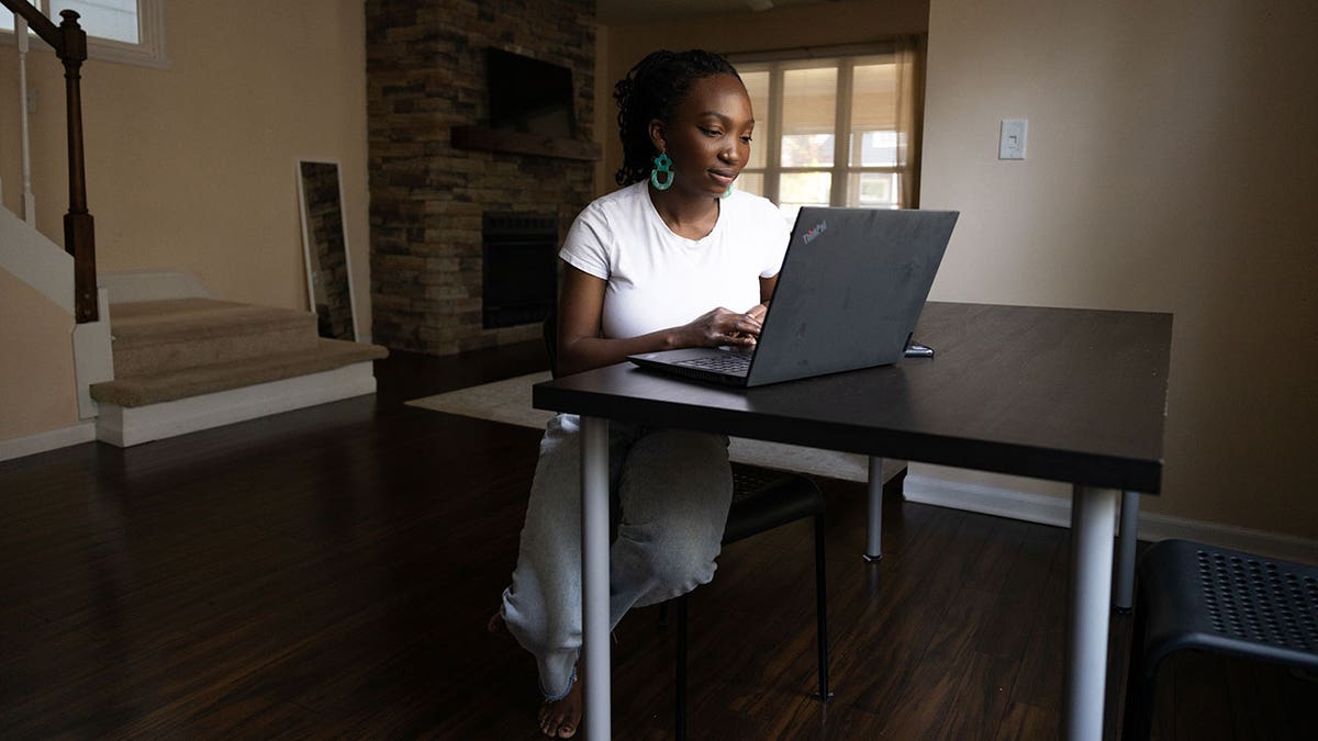 A Black woman working remotely