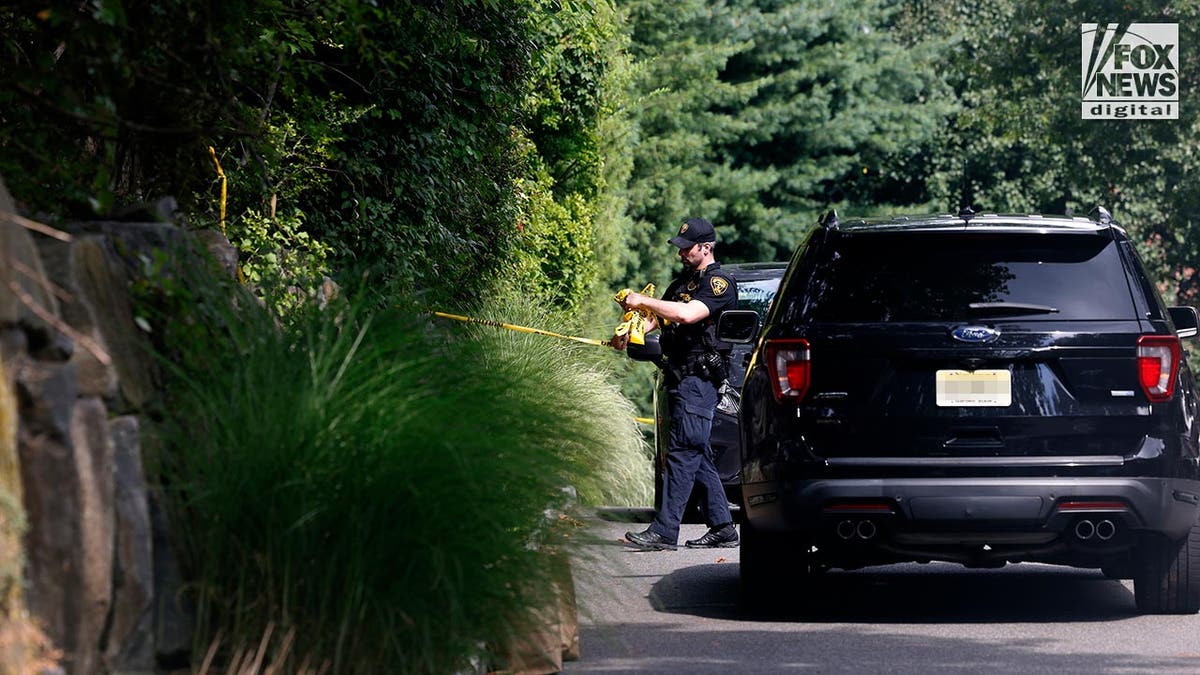 Police cars outside a suburban home