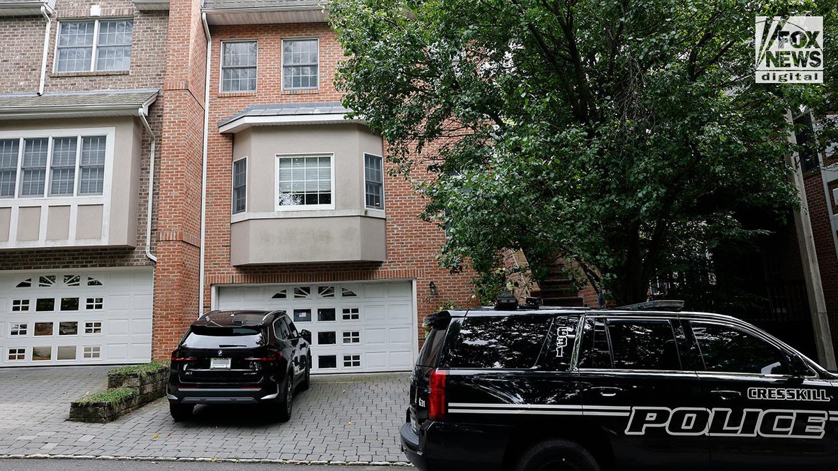 Police cars outside a suburban home