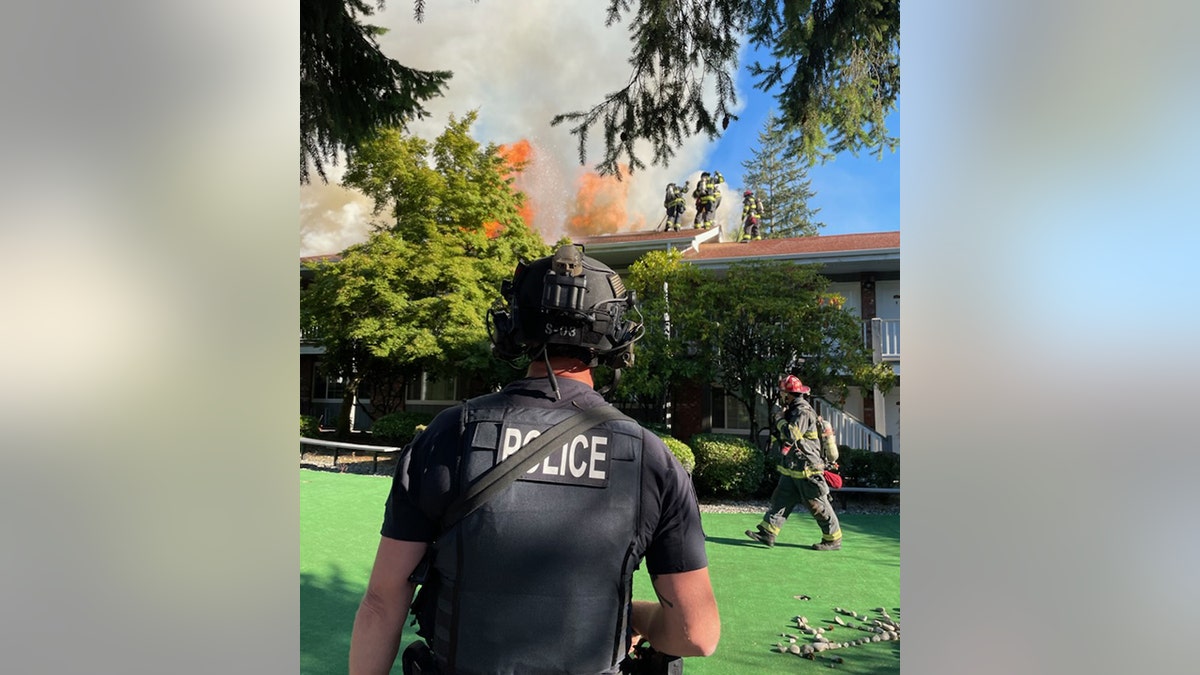 police officer in front of apartment building