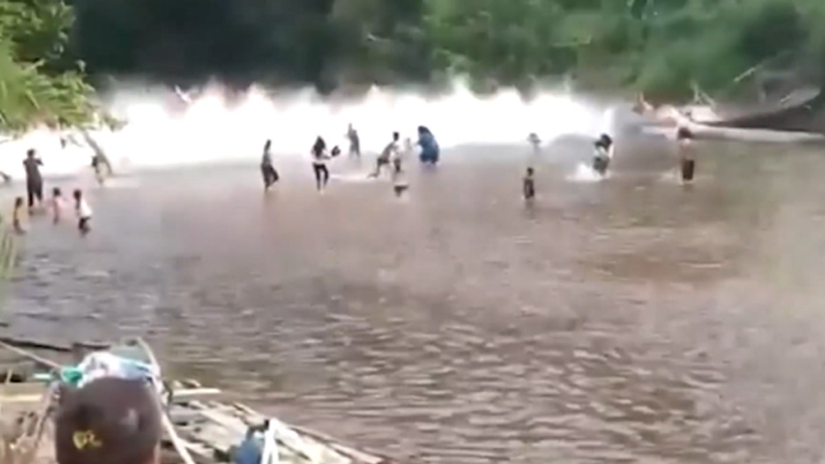 A bridge collapses, splashes in the water with people in Indonesia