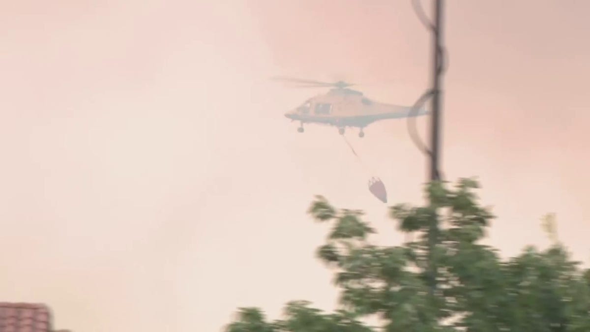 Helicopter dropping water on fire