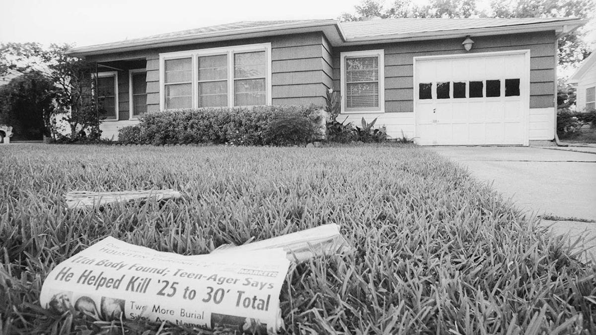 A newspaper sits in the front lawn of a house