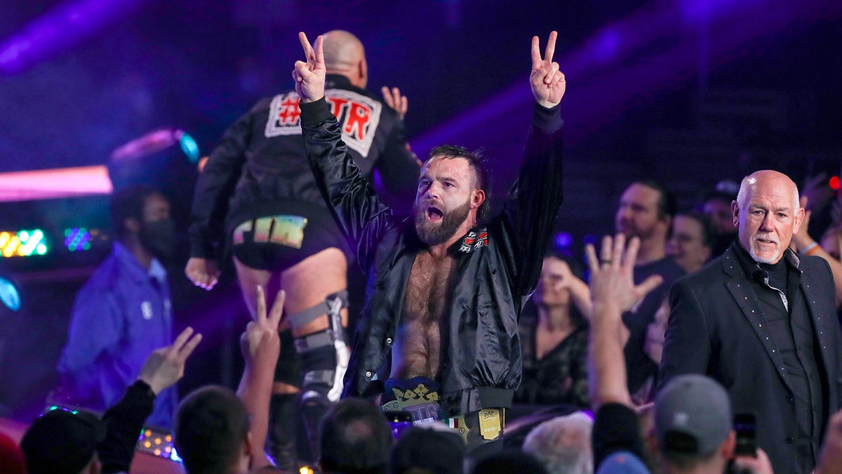 Cash Wheeler goes to the ring during an AEW event