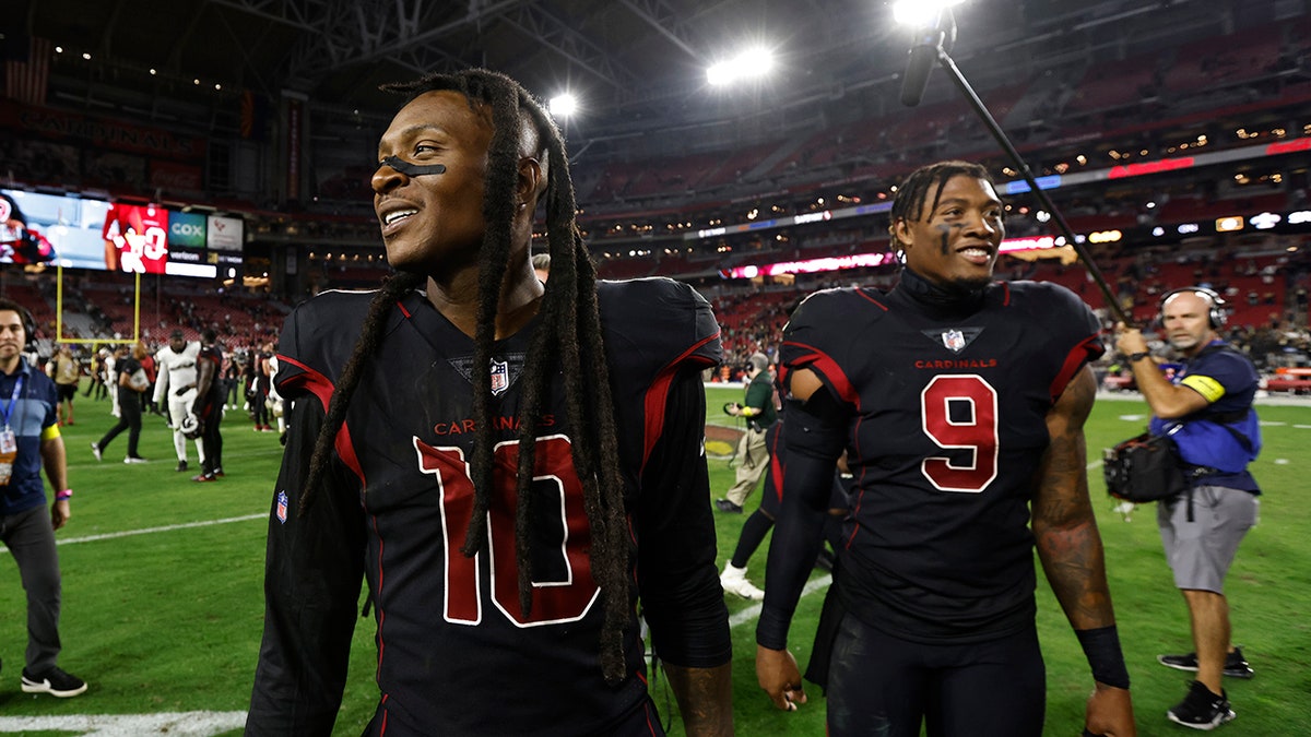 DeAndre Hopkins and Isaiah Simmons walk off field