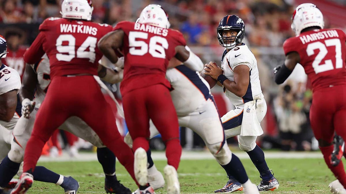 Russell Wilson looks to pass during a preseason game