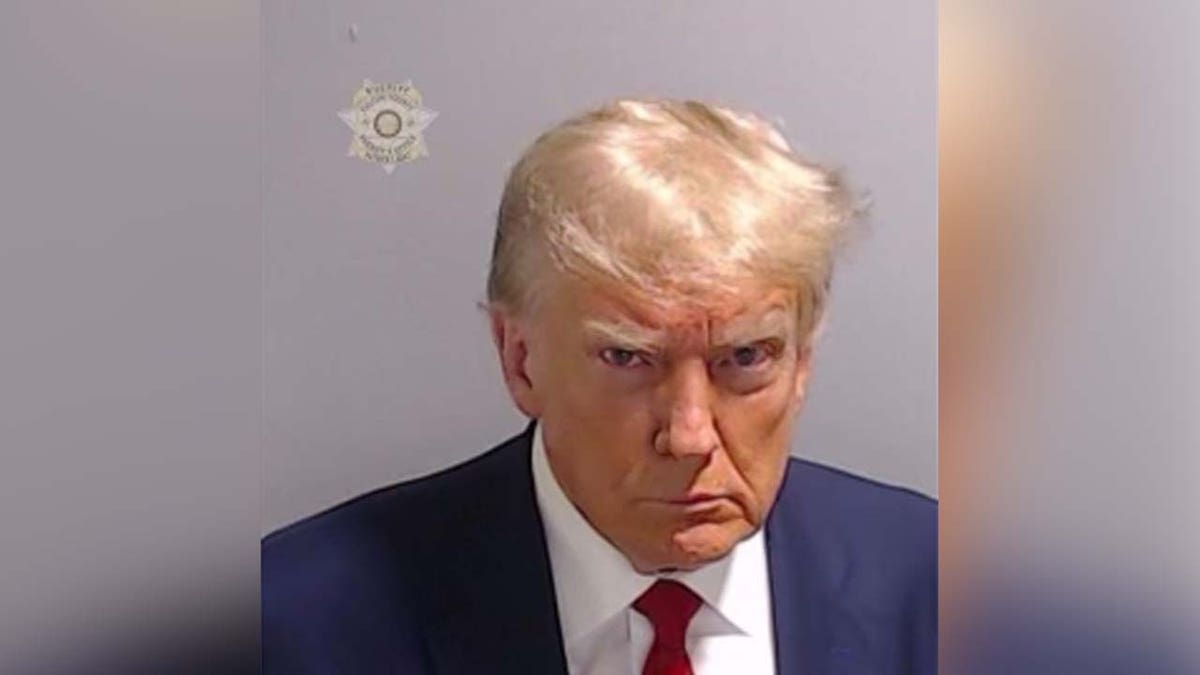 Trump scowling in mugshot